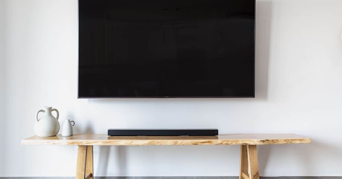 blank television on wall with tv stand sitting below